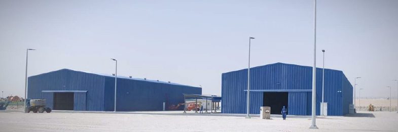 Two completed blue steel warehouses