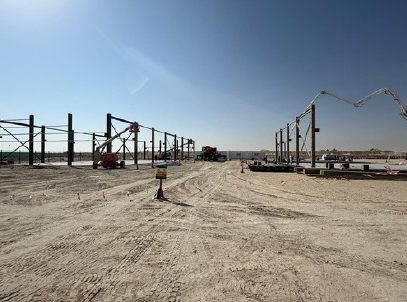 Steel columns erected across a desert site