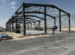 Steel building frame under a blue sky