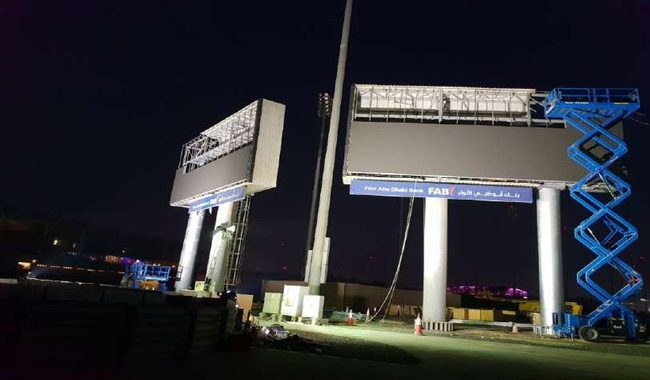 Screen structure on steel columns installed at night beside a lift